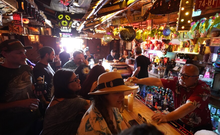 In this Wednesday, July 7, 2021, file photo, patrons enjoy tropical cocktails in the tiny interior of the Tiki-Ti bar as it reopens on Sunset Boulevard in Los Angeles.