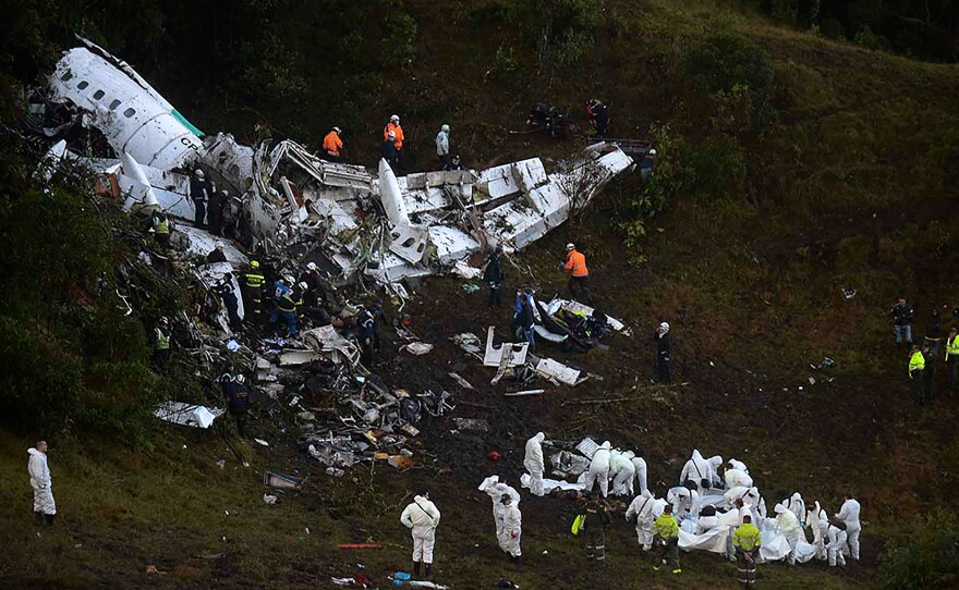 Rescuers search for survivors from the wreckage of the LAMIA airlines charter plane carrying members of the Chapecoense Real football team. The plane crashed in the mountains in Colombia late Monday, killing scores of people and leaving only a handful of survivors, officials said.
