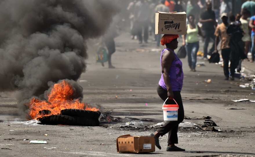 A tire placed by a small group of demonstrators burns on a street in the Pétion-Ville area of the Haitan capital Port-au-Prince, on Feb. 17.