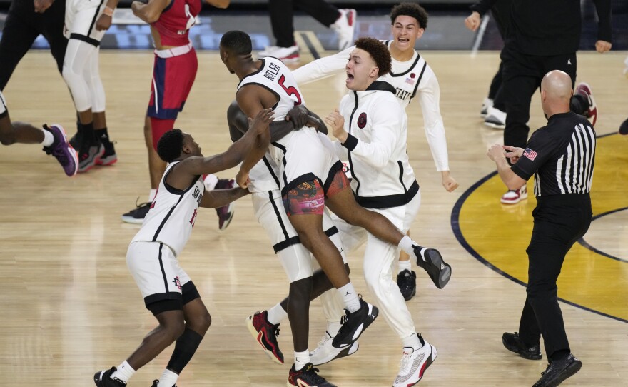 San Diego State guard Lamont Butler (5) celebrates with teammates after hitting the winning basket against Florida Atlantic during the second half of a Final Four college basketball game in the NCAA Tournament on Saturday, April 1, 2023, in Houston.