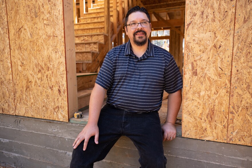 Victor Diaz sits on the foundation of the new home he is building to replace his home lost in the Caldor Fire, Thursday, August 4, 2022.