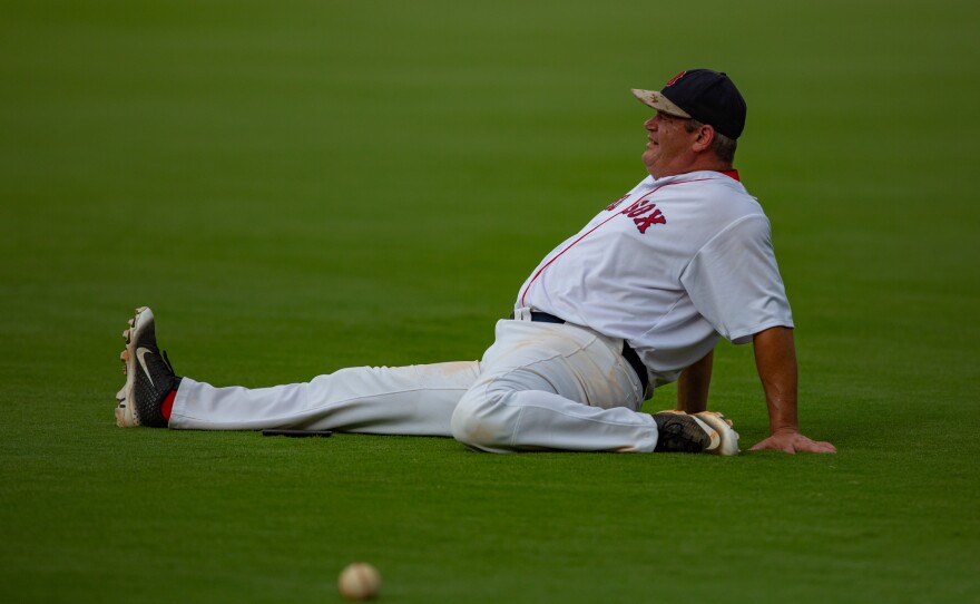 Stretching a little extra before game time is important for players like Kerry Maddox. But he wasn't all business. He brought his phone to snap a few pictures of the perfectly-manicured field.