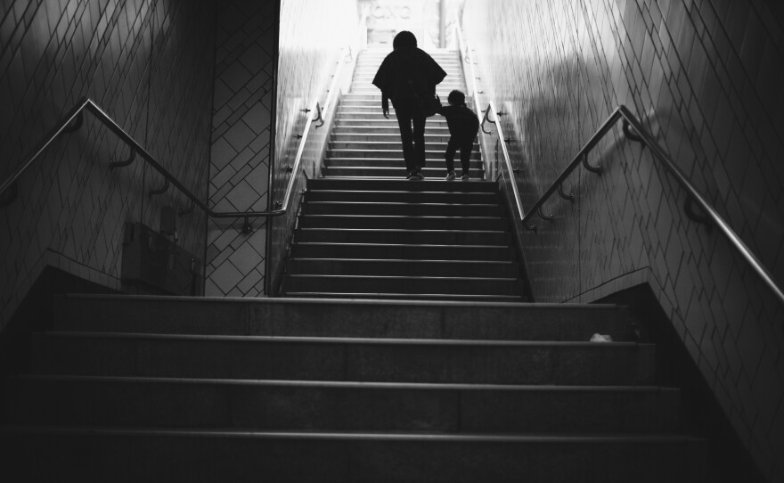 Seoul, Korea - Nov. 1, 2019: A woman and child ascend the staircase of a subway exit.