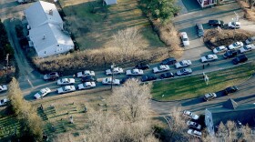 Police cars and other vehicles fill a road near the scene of a mass school shooting at Sandy Hook Elementary School on December 14, 2012 in Newtown, Connecticut.
