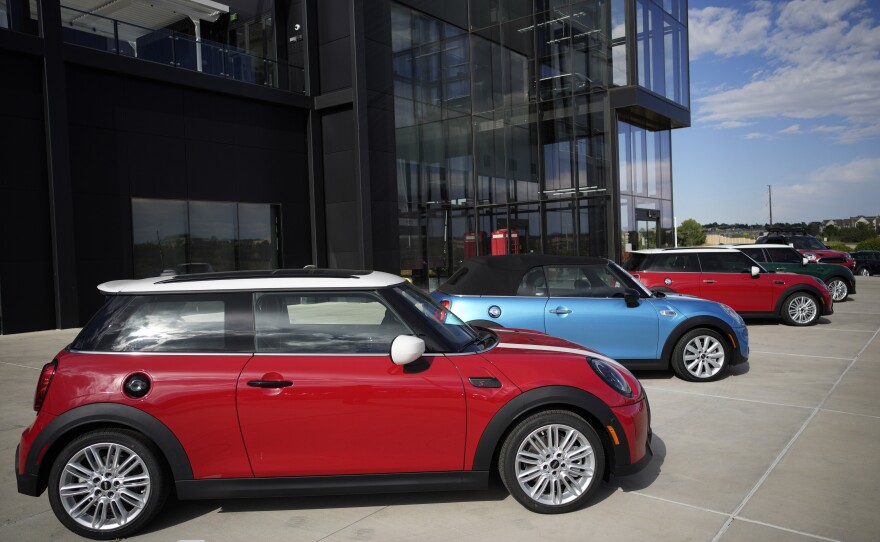 A small assortment of unsold 2022 models sits outside a Mini dealership in Highlands Ranch, Colo., on Sept. 12. Being flexible and staying patient are among the things to keep in mind if you are shopping for a car.