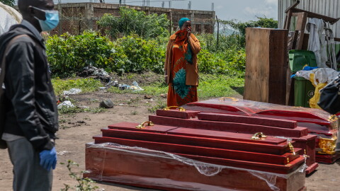 Family members of people who died of Ebola stand next to coffins at a health center in Rwampara, Congo, Wednesday, May 20, 2026.
