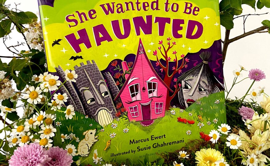 The cover of "She Wanted to be Haunted," illustrated by Susie Ghahremani, is pictured among flowers styled by Natalie Gill of Native Poppy.