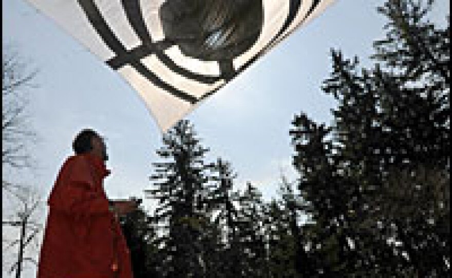 A Greenpeace protester looks at a target banner during a protest against a proposed U.S. radar base in the Czech Republic on April 28.