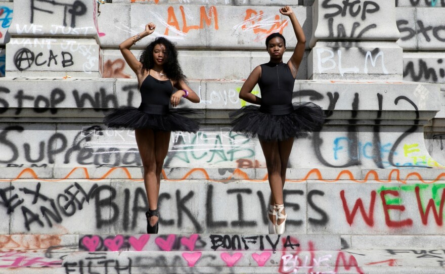 Ballerinas Kennedy George, 14, and Ava Holloway, 14, pose in front of a monument of Confederate general Robert E. Lee after Virginia Governor Ralph Northam ordered its removal after widespread civil unrest following the death in Minneapolis police custody of George Floyd, in Richmond, Va., on June 5.