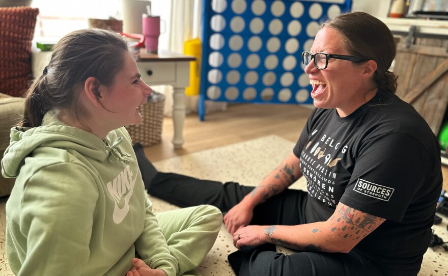 Emma Lenover, left, works through a literacy lesson at home with special education teacher Sarah Elston. Emma loves these visits and, on this day, waited anxiously at the picture window for Elston to arrive.