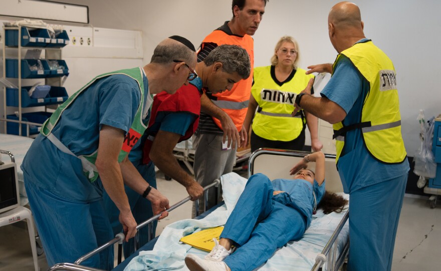 A team of hospital employees runs through a drill to practice in the underground hospital in Haifa.