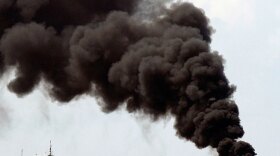 Smoke rises Friday, July 16, 2010, from a controlled burn of contained oil from the Deepwater Horizon oil well leak on the Gulf of Mexico near the coast of Louisiana.