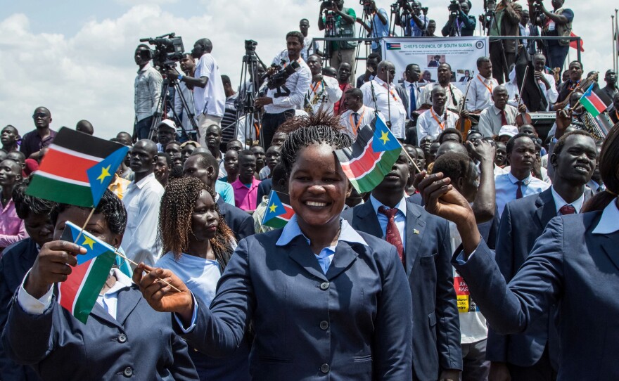 People waved the national flags of South Sudan during a peace ceremony in the capital city of Juba last Thursday. South Sudan rebel leader Riek Machar returned to Juba after two years of exile, saying he had come bearing a message of peace.