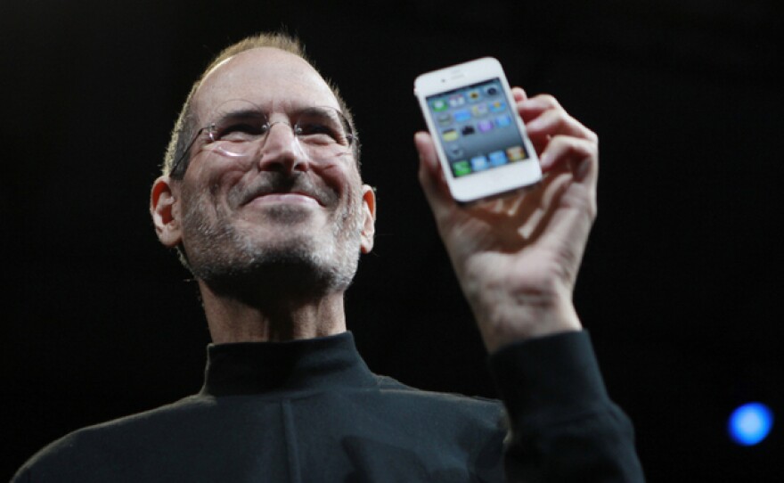 Steve Jobs holds up an iPhone at the Apple Worldwide Developers Conference in San Francisco in June 2010.