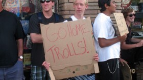 Dozens of people protest for and against a controversial bumper sticker reading "Welcome to Ocean Beach/Please don't feed our bums," on Newport Avenue in Ocean Beach on June 23, 2010.