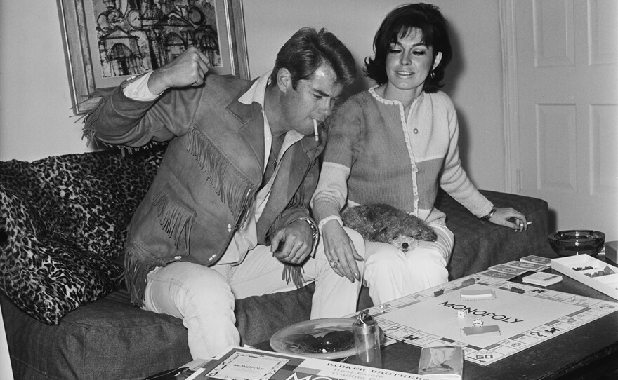 Actor Troy Donahue playing Monopoly at home in Beverly Hills, Calif., with his wife Valerie Allen. Circa 1967.