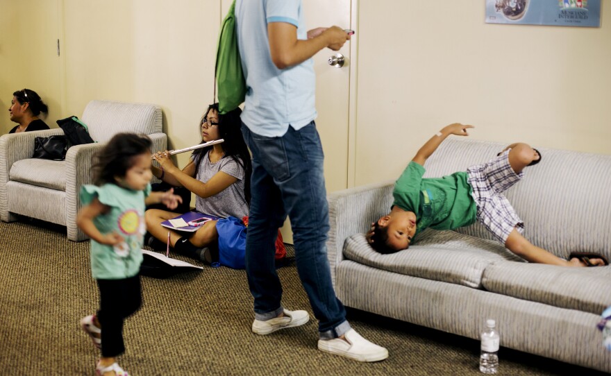 While Harmony Project students head into their practice rooms, the second-floor hallway fills with parents and siblings who wait for an hour — reading books, playing video games, or entertaining each other.