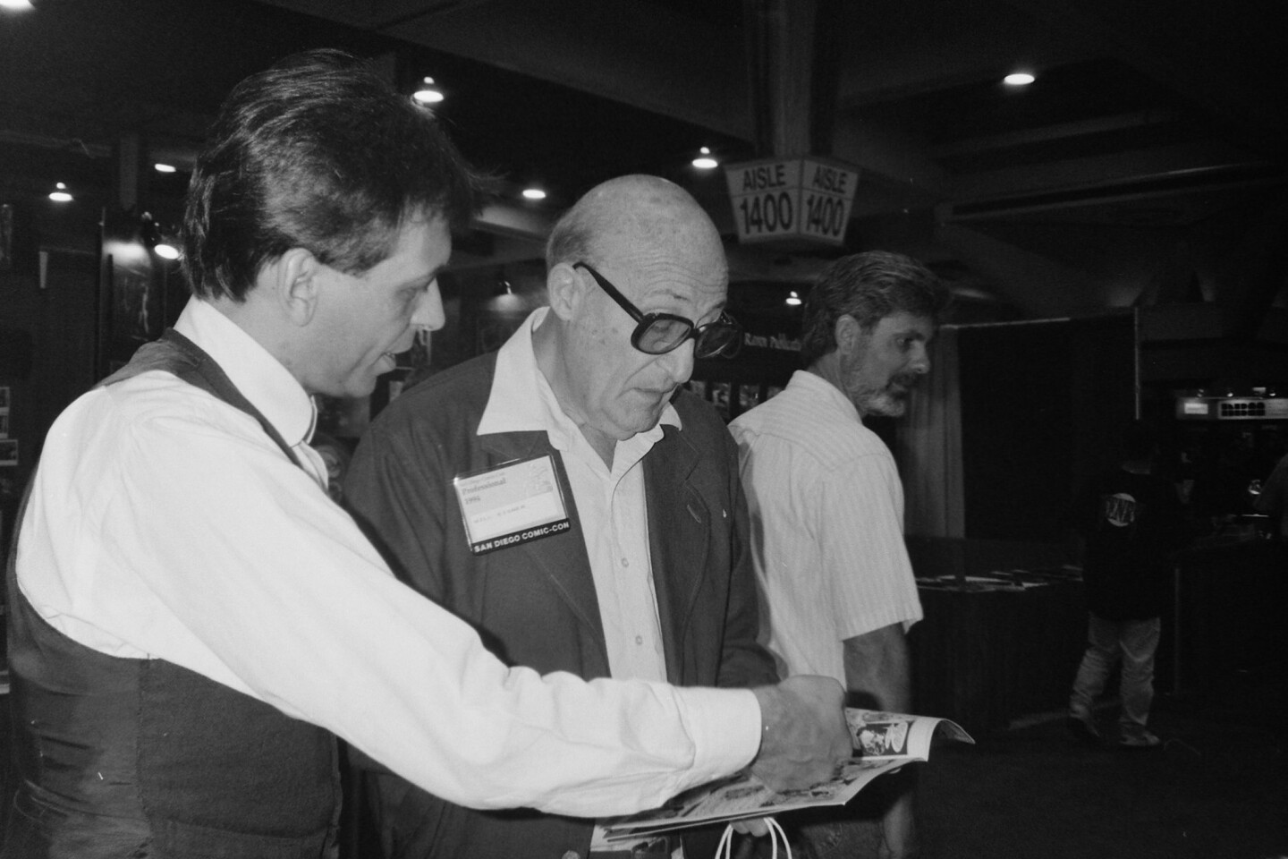 Cartoonists Batton Lash (left) and Will Eisner (right) check out a comic book at the 1994 Comic-Con Convention.