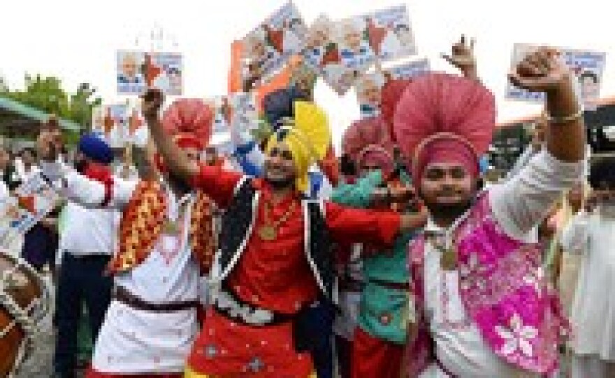 Indian artists dance as they wait for the arrival of the chief minister of the western Indian state of Gujarat and Bharatiya Janata Party prime-ministerial candidate Narendra Modi in New Delhi on Saturday.