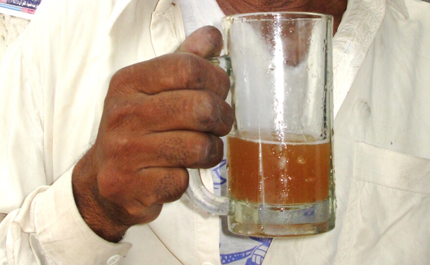 A man drinks aloo pokhara, a heart-comforting prune juice in Islamabad.