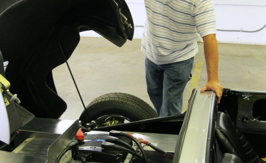 Brian Noto shows what's going on under the hood of a replica 1957 Porsche 356 Speedster in EVTV's Cape Girardeau, Mo., garage. The car runs on lithium iron phosphate batteries.