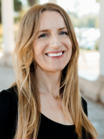 Woman smiling wearing a black shirt.