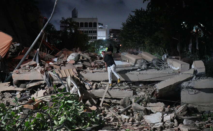 A man jumps on a collapsed building after an earthquake in Caracas, Venezuela.