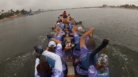 Team Survivor members paddle their dragon boat.