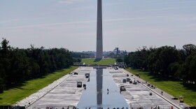 Workers refill the Lincoln Memorial Reflecting Pool on Friday, after a weeks-long project to resurface and repaint the basin.