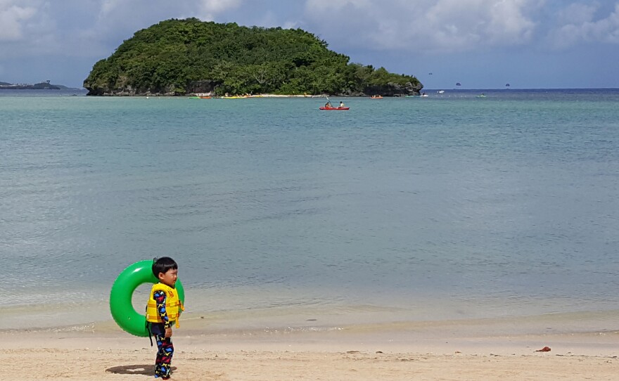 A child plays on a beach in Guam's capital, Hagatna, on July 14. About 163,000 people live on the island.