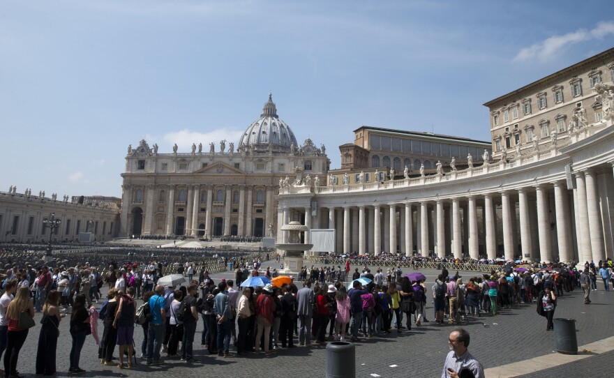 People line up to visit St. Peter's Basilica at the Vatican, on April 15. Although flights to Europe remain expensive, the falling euro is still leading to a surge in American tourists visiting Europe.