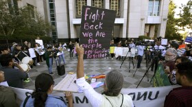 In this June 20, 2018, file photo, protesters demonstrate outside the federal courthouse in Sacramento, Calif., where a judge heard arguments over the U.S. Justice Department's request to block three California laws that extend protections to people in the country illegally. 