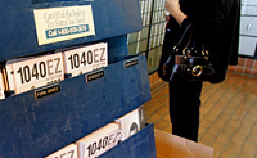 Federal tax forms on display at a U.S. Post Office in Palo Alto, Calif. Taxpayers could receive rebates of up to of $300 to $1,200 per household under a new stimulus plan.