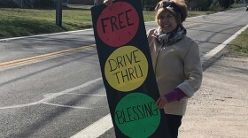 Carol Day, a lay volunteer at Centenary Methodist Church in Shady Side, Md., invites passers by to stop for a blessing.
