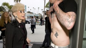 Sally Thornton checks out Matthew Vanerin's tattoos. 