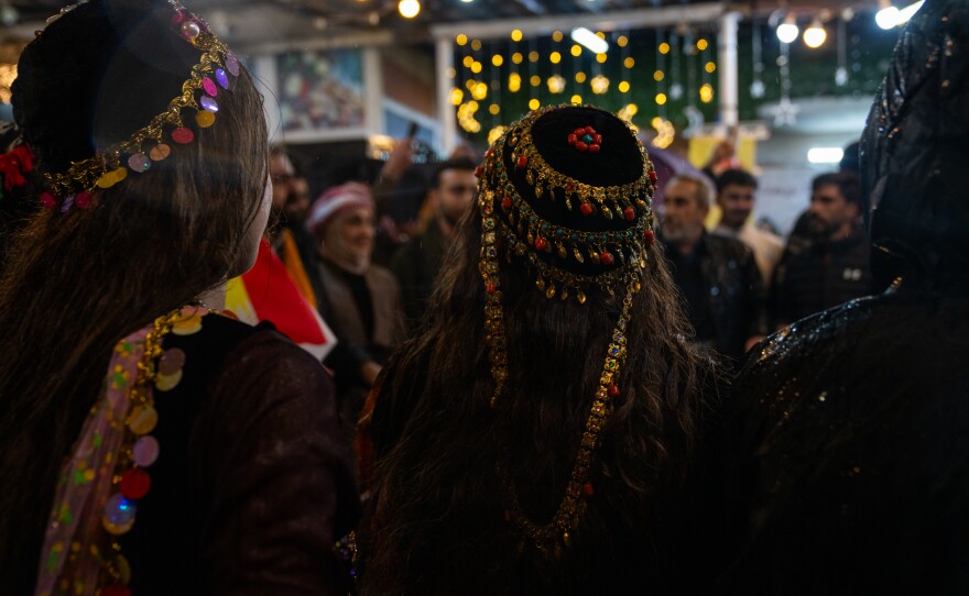 Women wear Kurdish headdresses on Friday while gathering in the city's plaza.