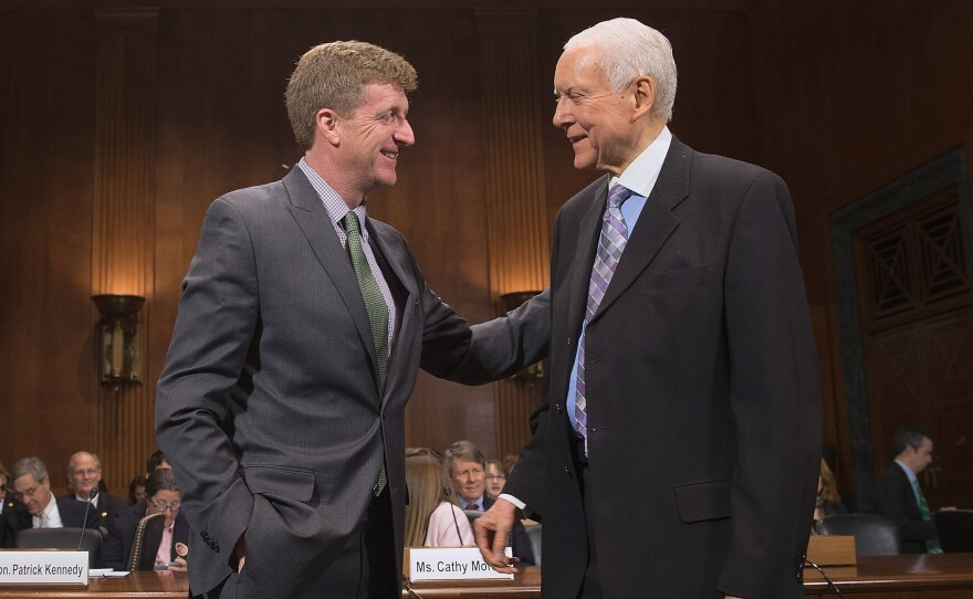 Former Rep. Patrick Kennedy (left) is welcomed by Sen. Orrin Hatch, R-Utah, during a hearing about mental health parity rules Thursday. A new rule issued by the Obama administration aims to increase parity for how insurers handle mental health issues.