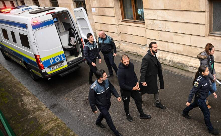 Andrew Tate (center left) and his brother Tristan Tate (center right) arrive at the Court of Appeal in Bucharest, Romania, on Feb. 27, 2023.