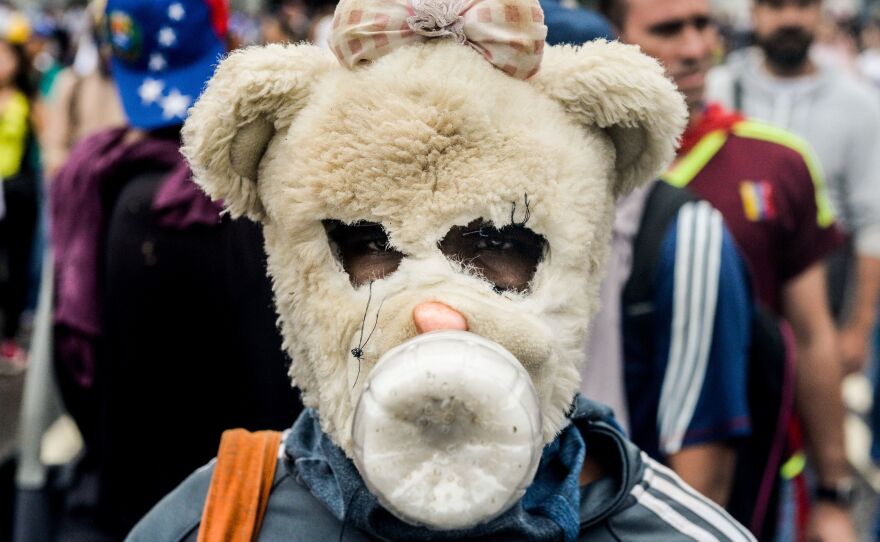 One opposition activist got creative (and fairly creepy) with a mask to protect against police officers' crowd-control devices. Dozens of people have been injured and more than 100 arrested since April 6, according to authorities.