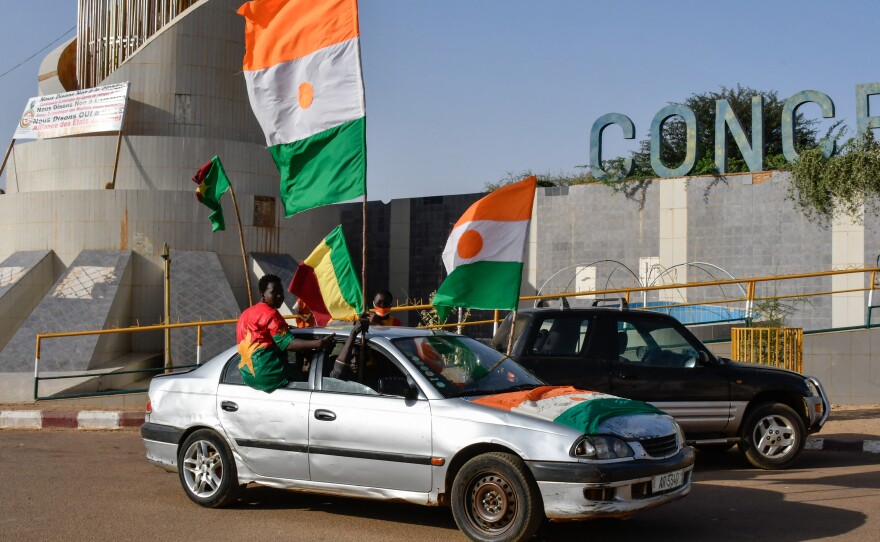 Supporters of the Alliance Of Sahel States (AES) drive with flags as they celebrate Mali, Burkina Faso and Niger leaving the Economic Community of West African States (ECOWAS) in Niamey on January 28, 2024.