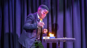 Lubelo Mthenjana, who's 11, performs a magic trick involving fire during the annual junior magic contest at the College of Magic in Cape Town, South Africa.