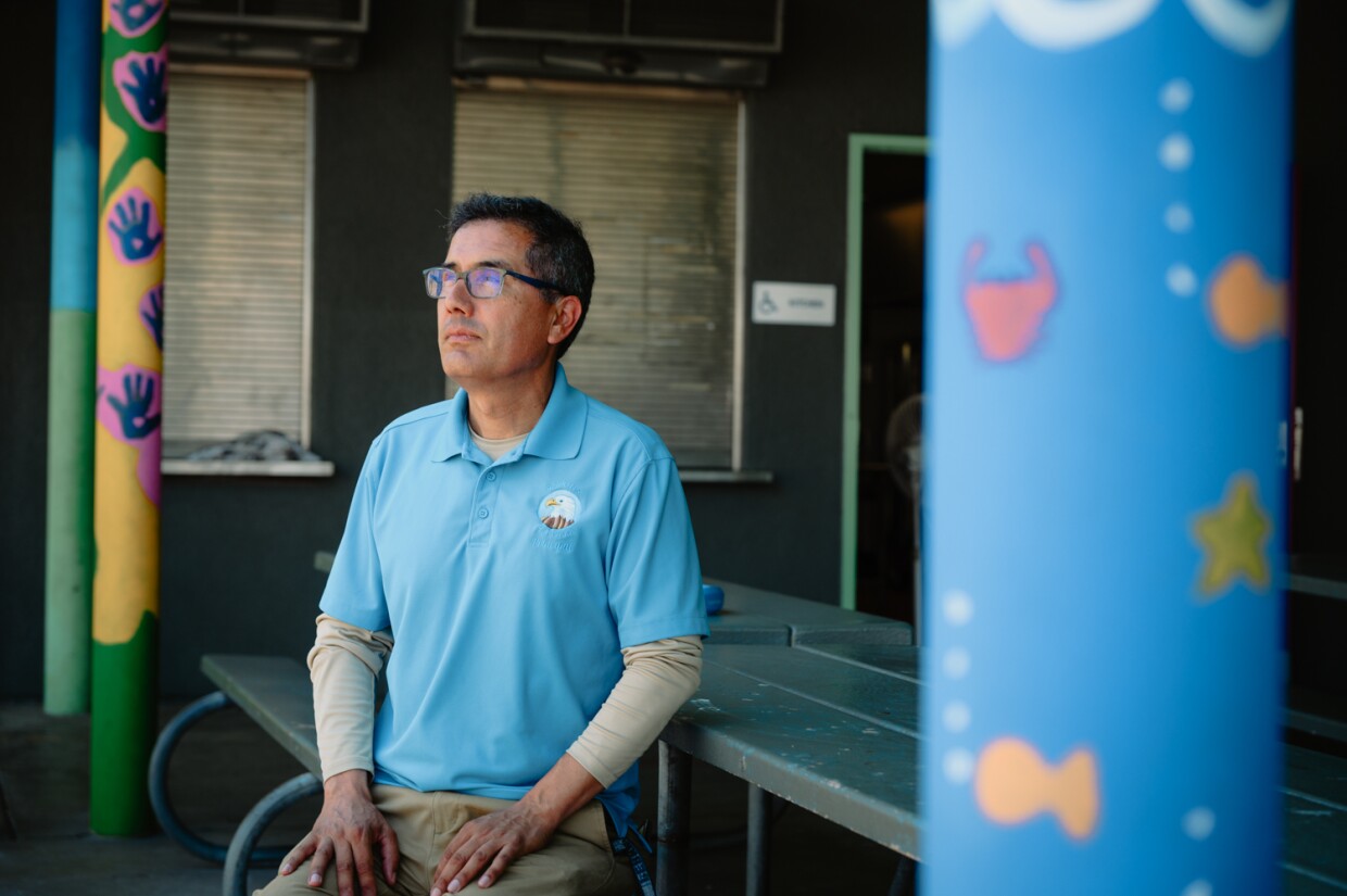 Perkins K-8 Principal Fernando Hernandez sits for a portrait at the school’s lunch tables in San Diego, California on September 10, 2024.