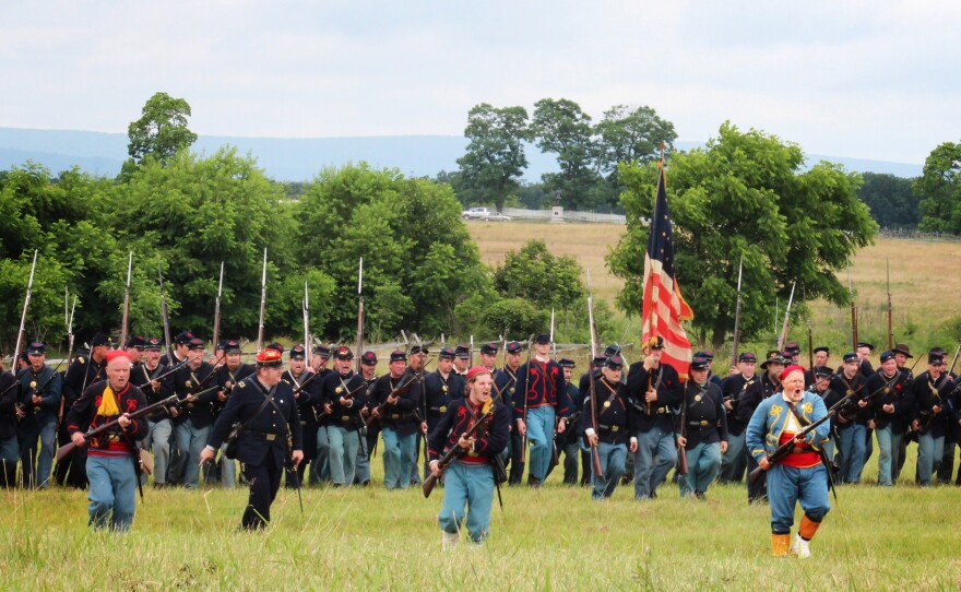 Men dressed as members of the Union infantry demonstrate battalion formations for tourists.