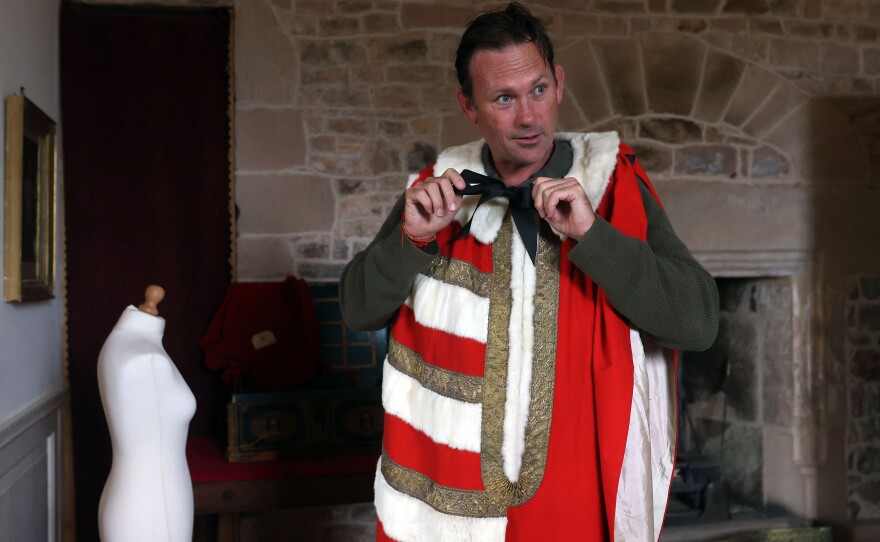 Aristocrat Charles Courtenay, 19th Earl of Devon, tries on vintage ceremonial robes for the State Opening of Parliament.