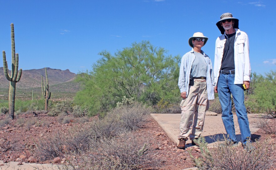 Owen (left) and Penson stand on marker "Y57," located at the southwestern edge of a massive 289-square-mile grid of concrete X's.