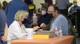 A man receives a COVID-19 vaccine at the vaccination super station at Grossmont Center in La Mesa, Calif. Feb. 2, 2021.