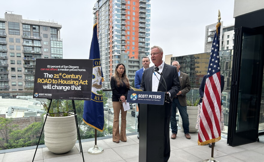 Rep. Scott Peters, D-San Diego, speaks at a media event highlighting the importance of the 21st Century ROAD to Housing Act. Behind him are Carlynne Yu, CFO of the Regional Task Force on Homelessness; James Silverwood, President of Affirmed Housing; and Stephen Russel, President and CEO of the San Diego Housing Federation.