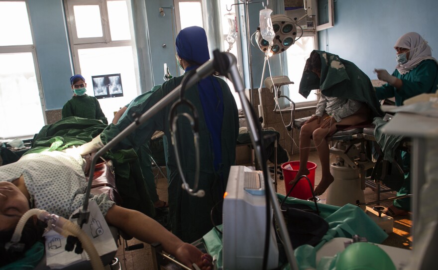 "This is a fistula repair in Kabul, Afghanistan, with two surgeries going on side by side," Addario says. "A fistula is a tear, often between the vagina and the anus. It's common in many countries with child marriage, or where women have birth very young. It's quite a shame — often women are shunned from their houses or don't get care — there's often a smell associated with fistula."