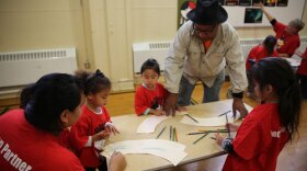 Therman Statom working with Yates Preschool students. Follow artists committed to passing on their skills and passion for craft to new generations. 