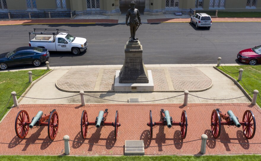A statue of Confederate General Stonewall Jackson stands behind cannons at the entrance to the barracks at Virginia Military Institute in this July photo. Superintendent J.H. Binford Peay III resigned on Monday amid allegations that the school's culture was hostile to Black cadets.